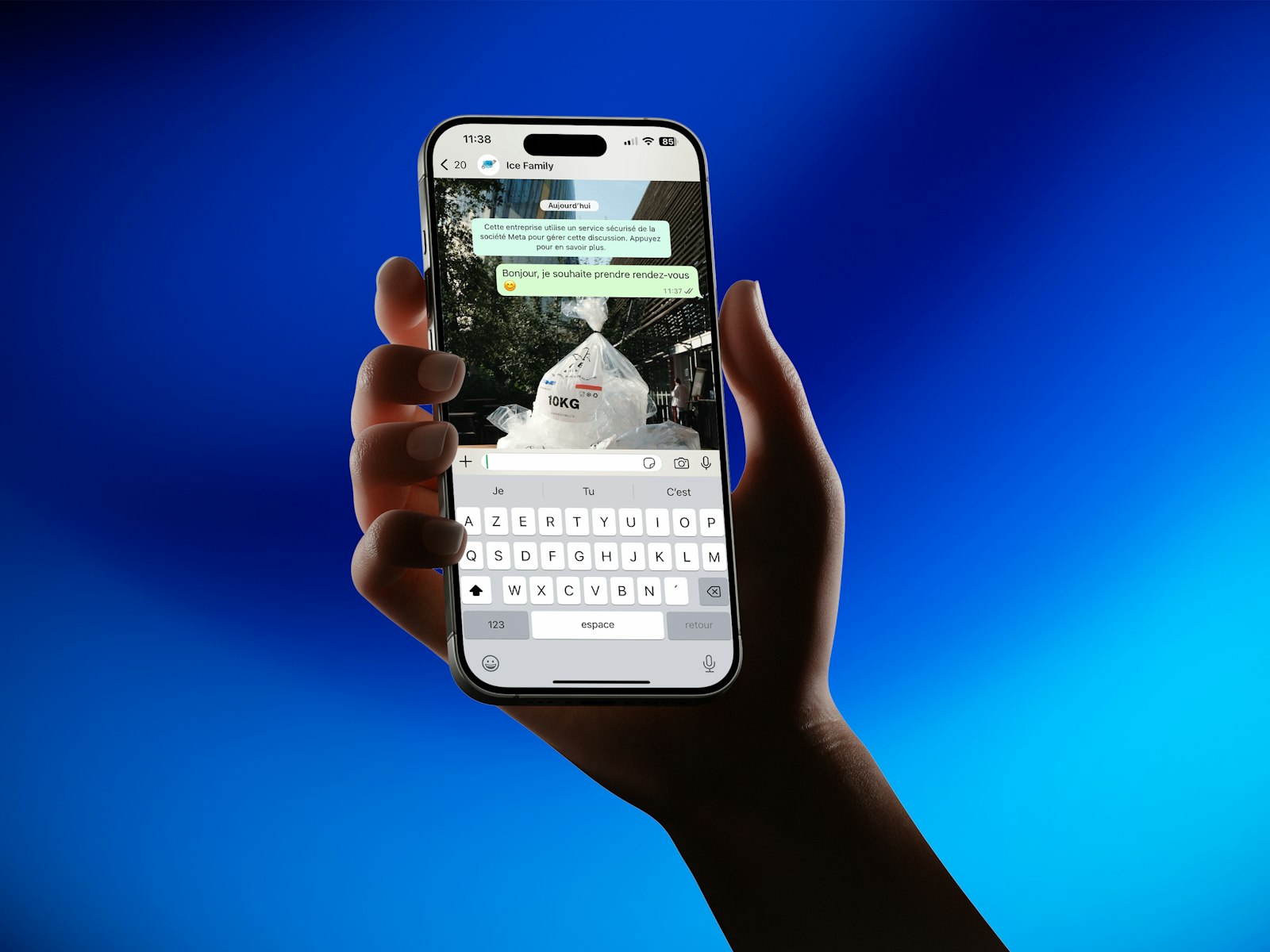 Hand holding a smartphone showing a messaging app interface