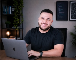 Gustavo Garcia wearing a formal shirt with his arms crossed